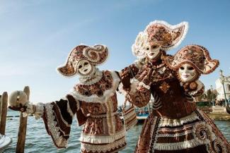 masked performers on a dock